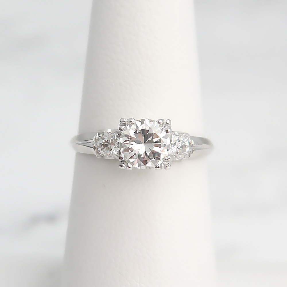 Round-cut diamond solitaire engagement ring with a touch of Yaffie Gold and  1/4ct total diamond weight, set perfectly in a sleek bezel design.